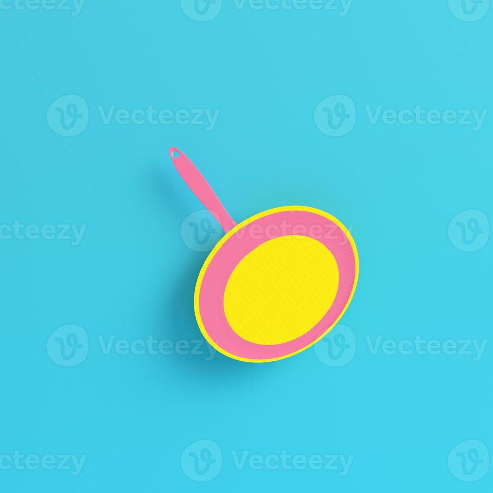Yellow frying pan on bright blue background in pastel colors photo