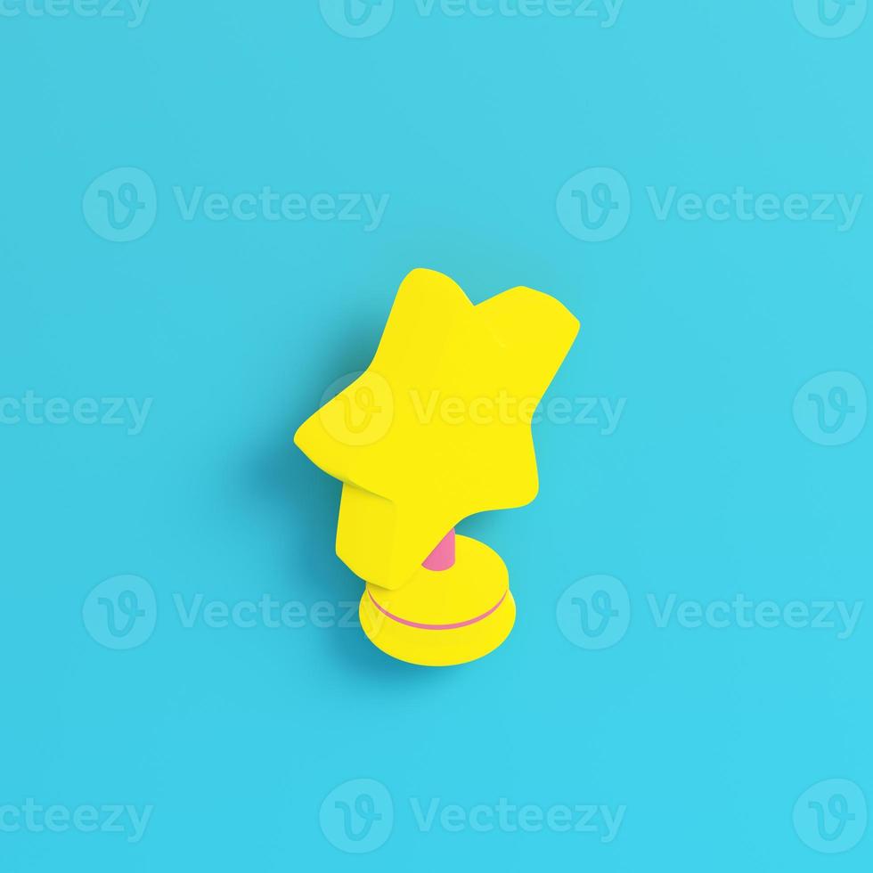 Yellow star with stand on bright blue background in pastel colors. Minimalism concept photo