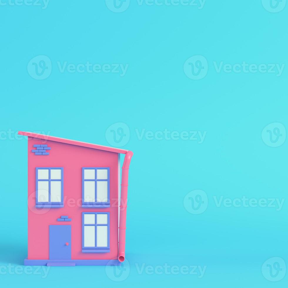 Pink cartoon styled house on bright blue background in pastel colors photo