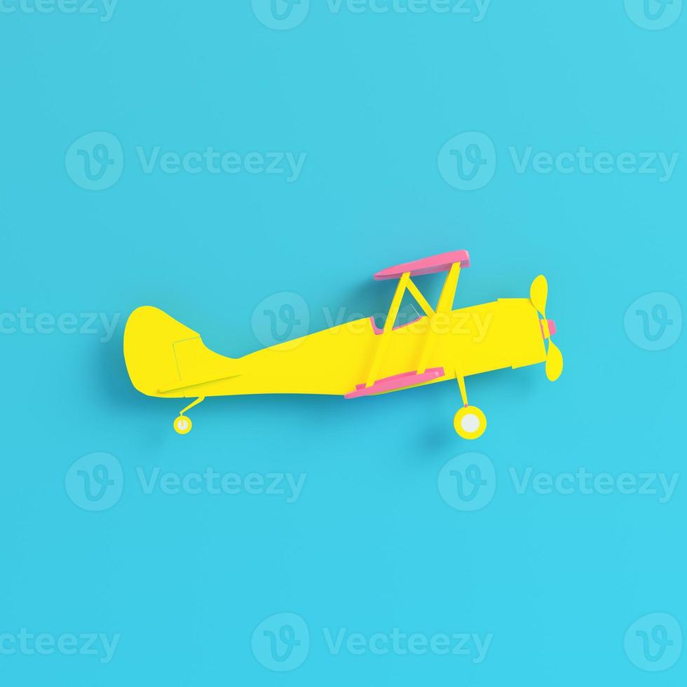 Yellow biplane on bright blue background in pastel colors. Minimalism concept photo