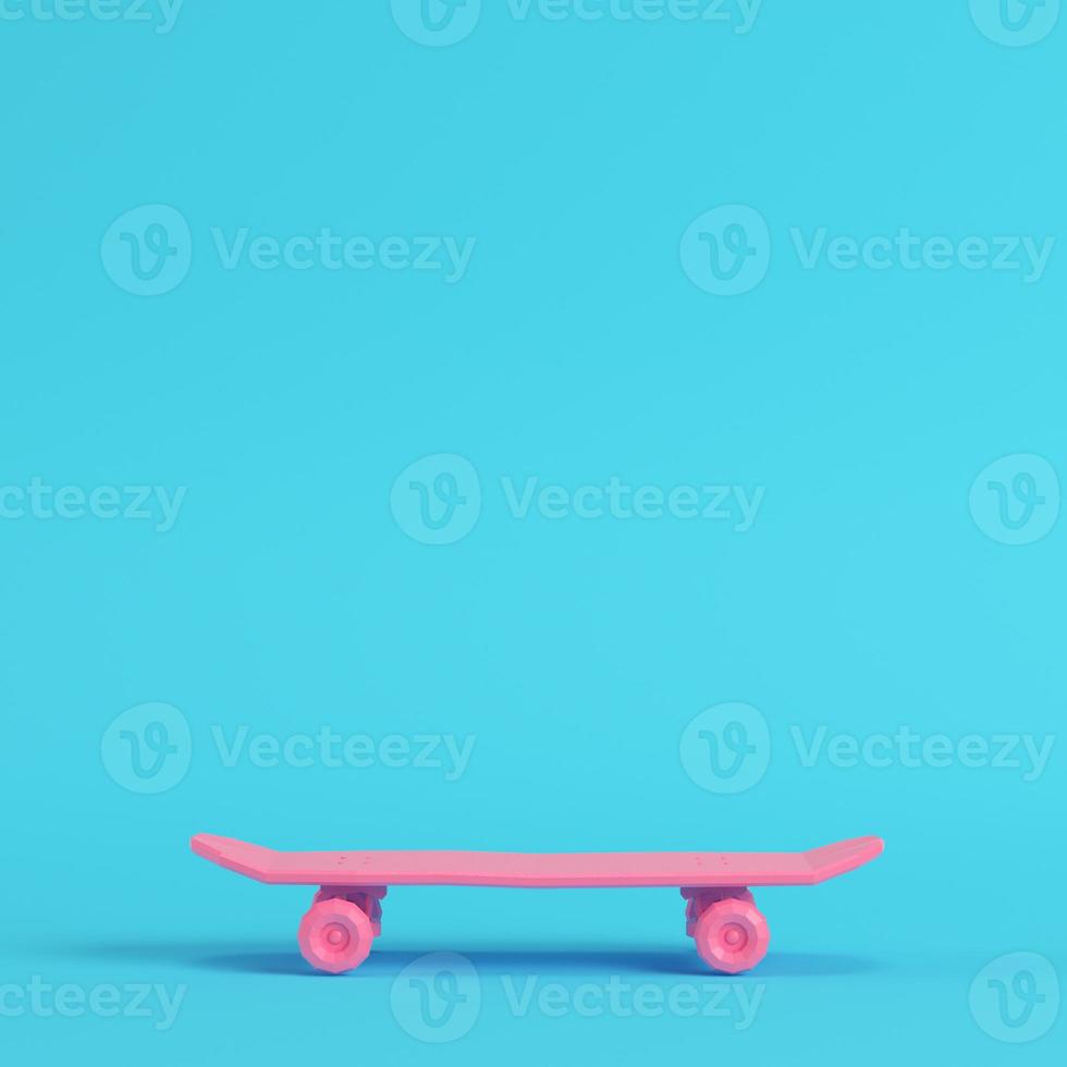 Pink low poly skateboard deck on bright blue background in pastel colors photo