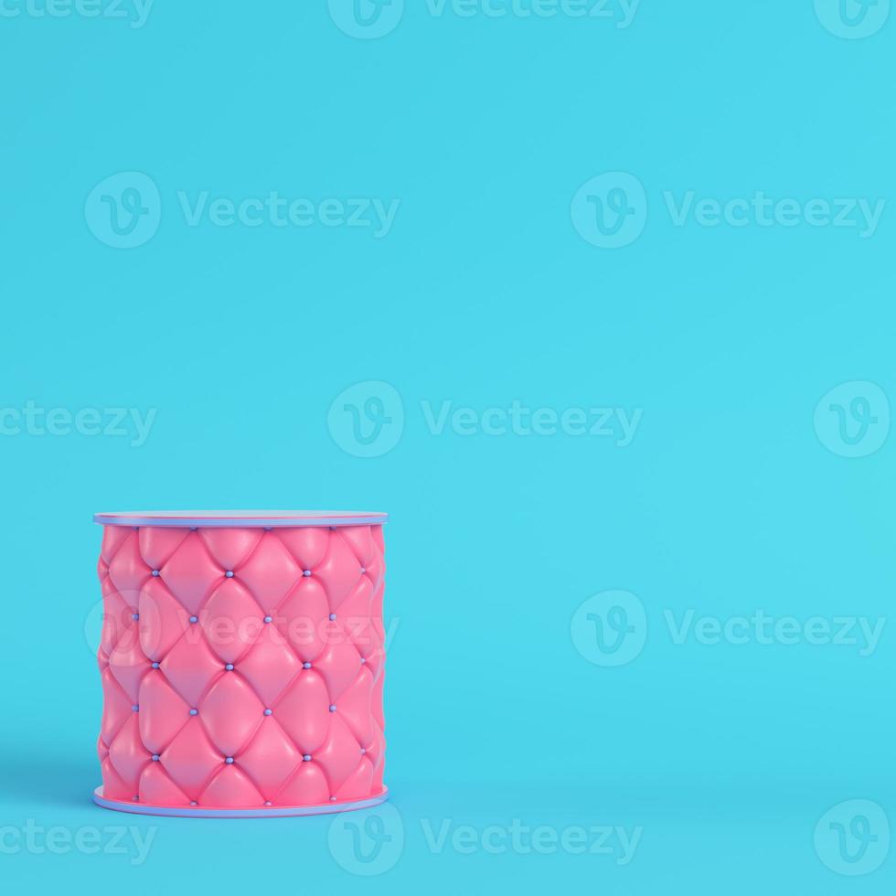 Pink stitched pedestal on bright blue background in pastel colors photo