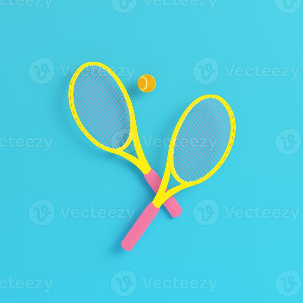 Yellow tennis rackets with ball on bright blue background in pastel colors photo