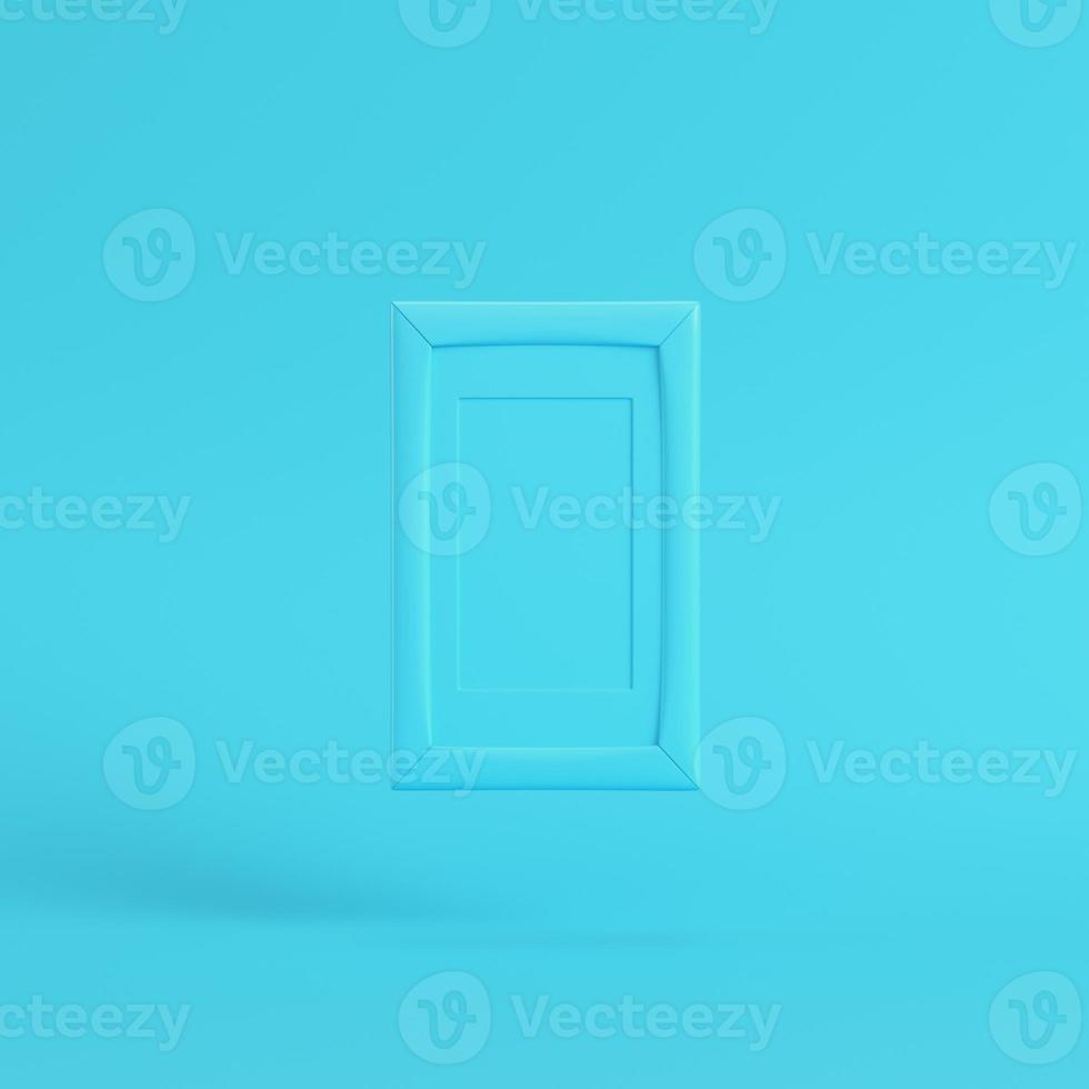 Blank frame on bright blue background in pastel colors photo