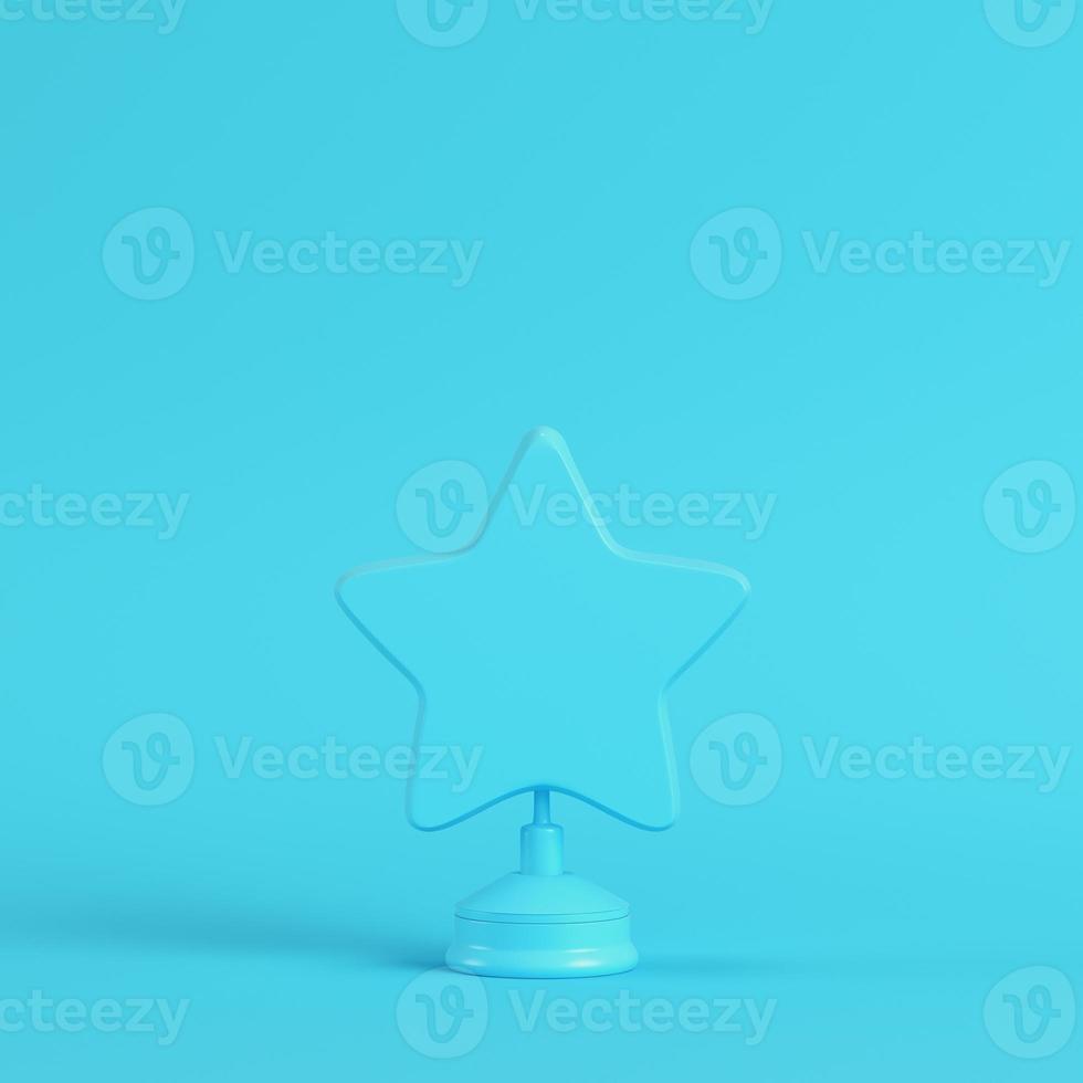 Star with stand on bright blue background in pastel colors. Minimalism concept photo