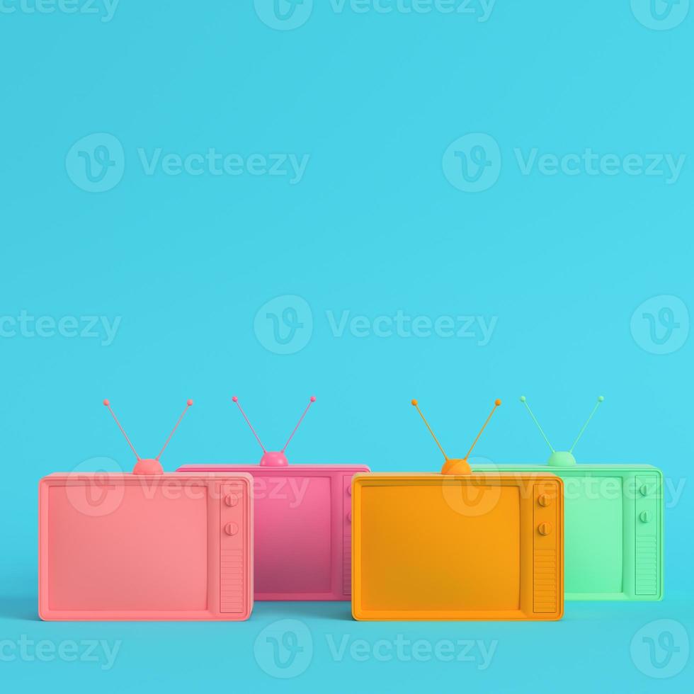 Four colorful retro styled tvs on bright blue background in pastel colors photo