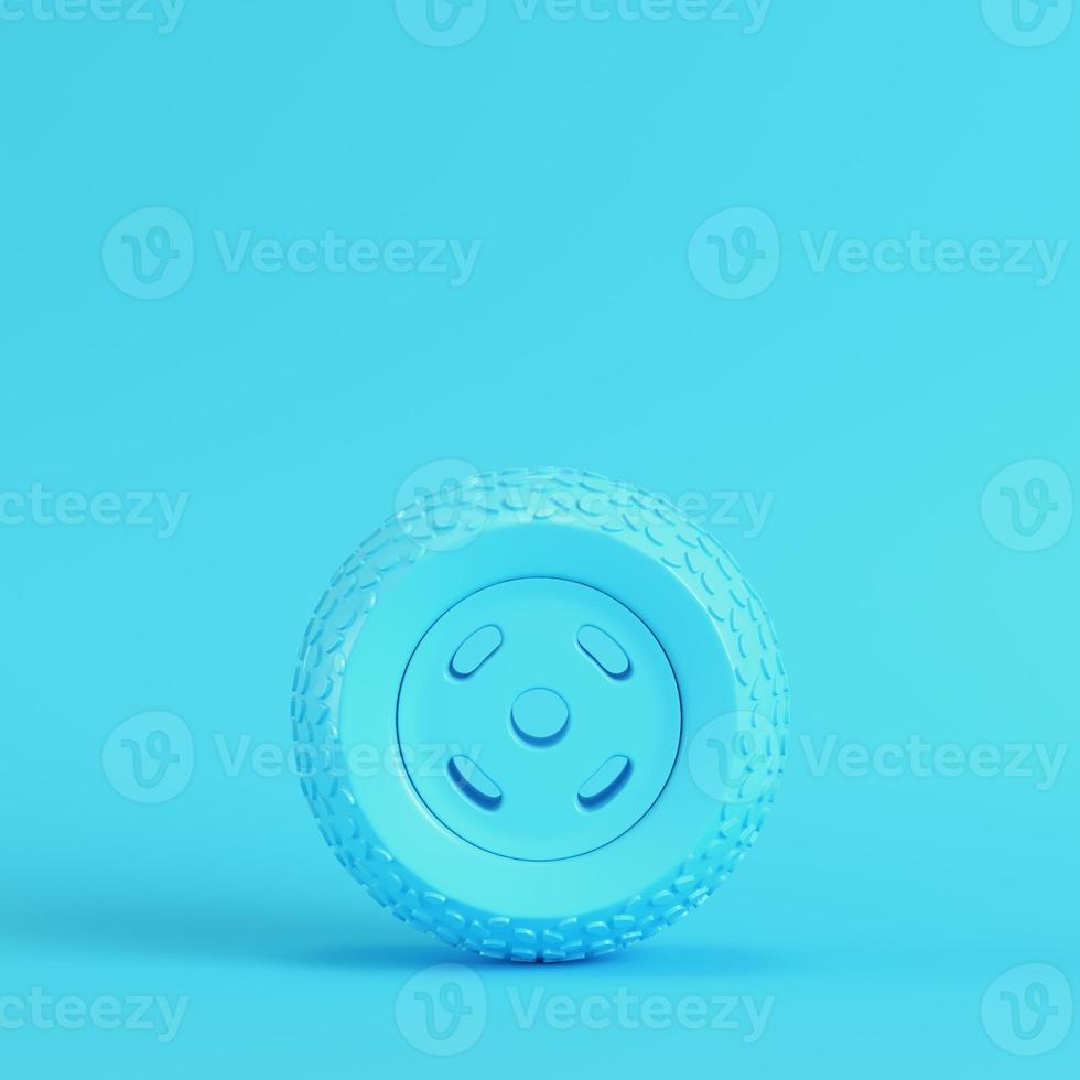 Car wheel on bright blue background in pastel colors. Minimalism concept photo