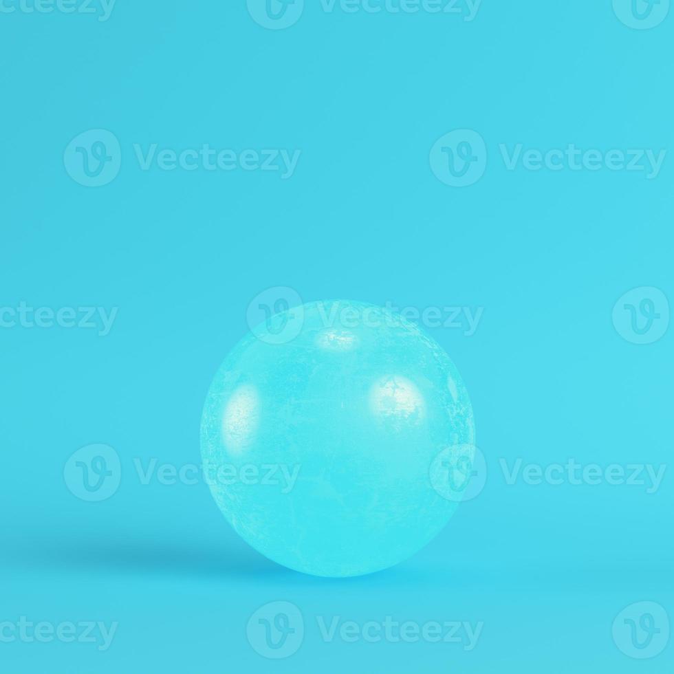 Crystal ball on bright blue background in pastel colors photo