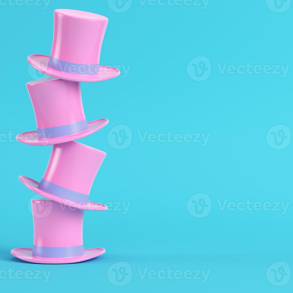 Pink top hats on bright blue background in pastel colors. Minimalism concept photo