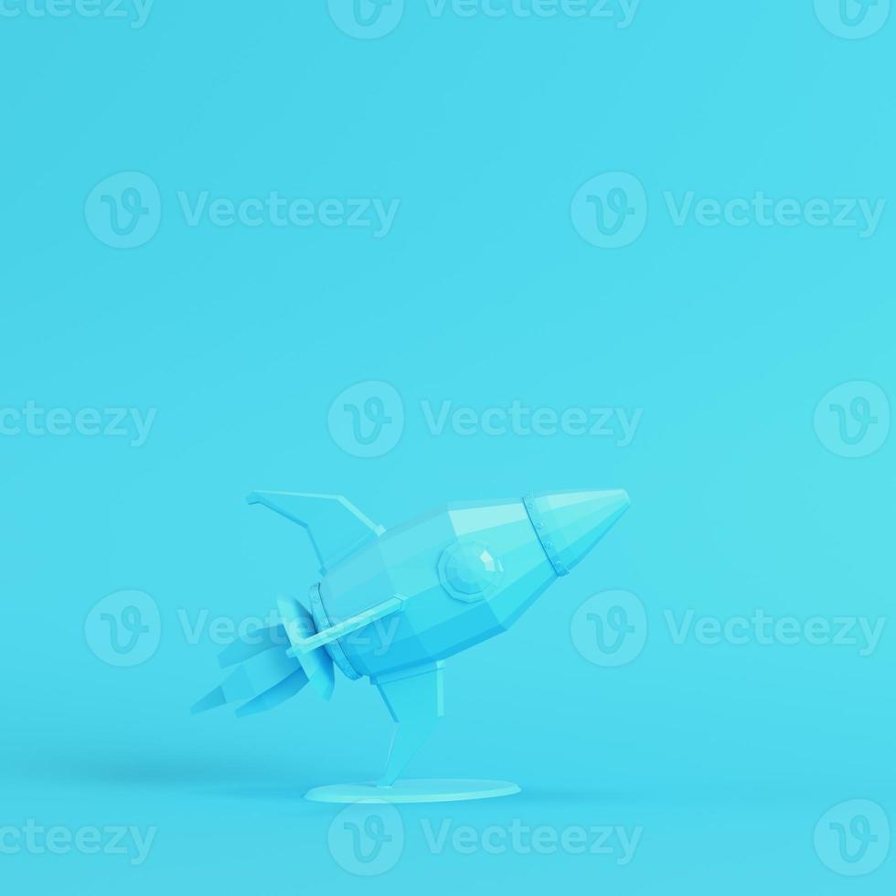 Rocket with stand on bright blue background in pastel colors. Minimalism concept photo