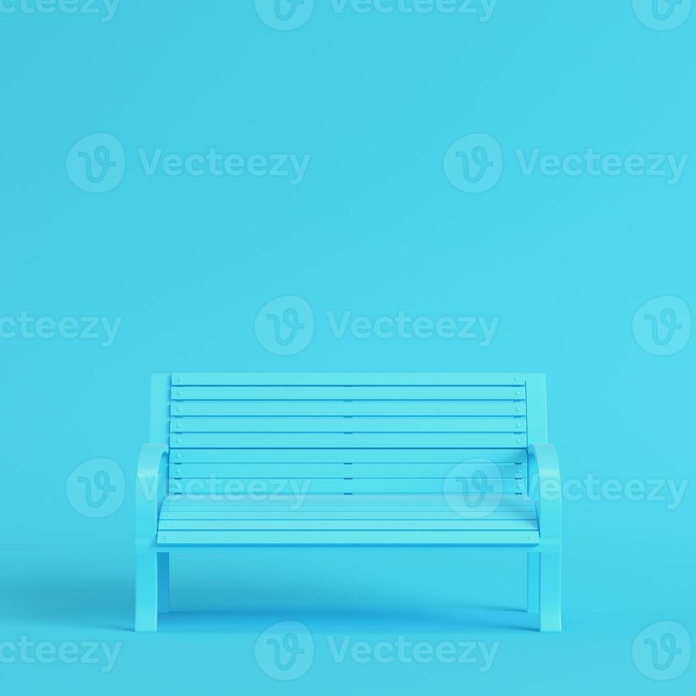 Street bench on bright blue background in pastel colors. Minimalism concept photo
