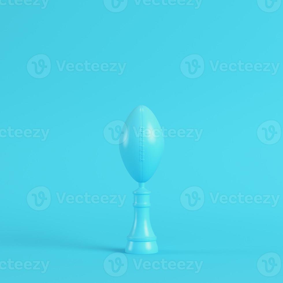 American football ball throphy on bright blue background in pastel colors. Minimalism concept photo