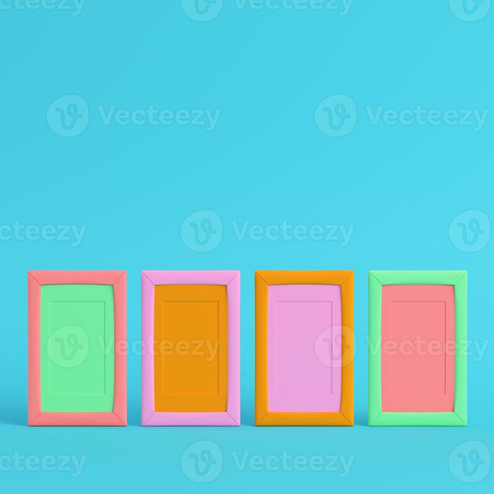 Four colorful blank frames on bright blue background in pastel colors photo