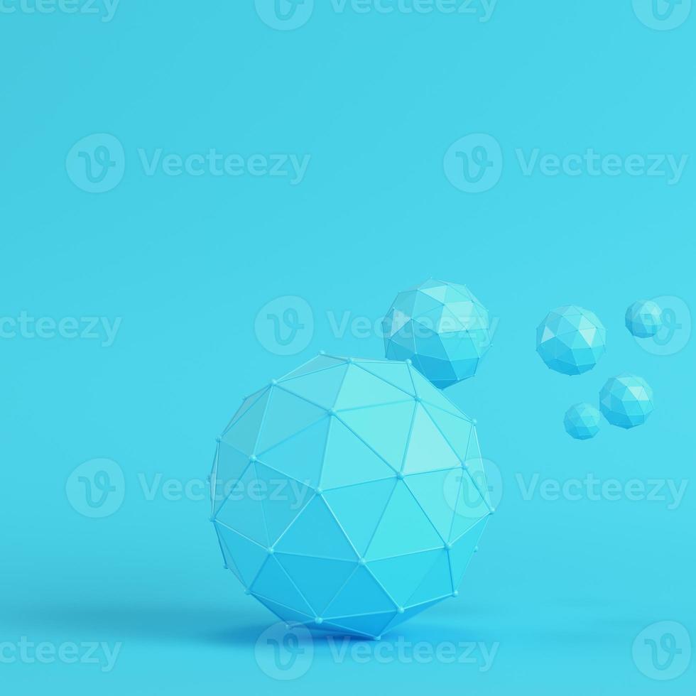 Low poly abstract spheres on bright blue background in pastel colors photo