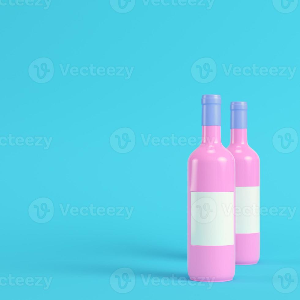 Two wine bottles with blank lables on bright blue background in pastel colors. Minimalism concept photo