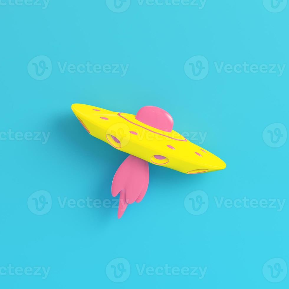 Yellow ufo or alien starship on bright blue background in pastel colors photo