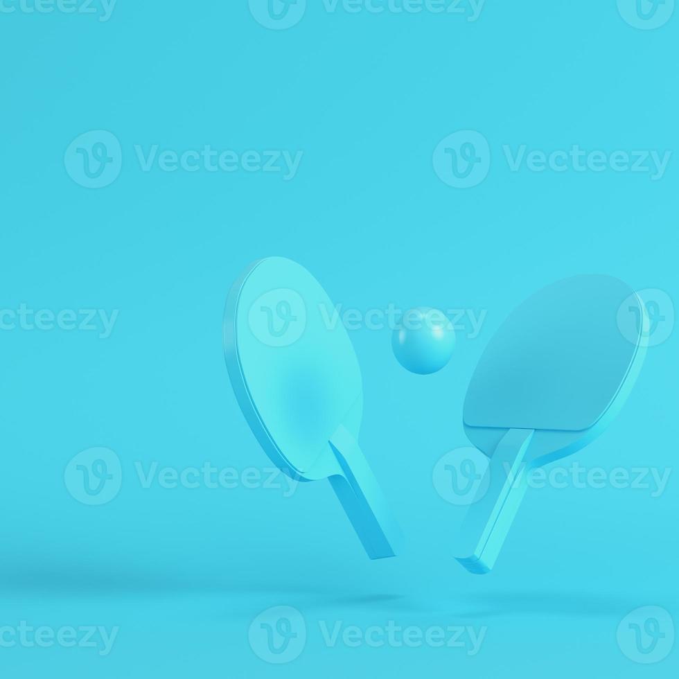 Ping pong rackets with ball on bright blue background in pastel colors. Minimalism concept photo