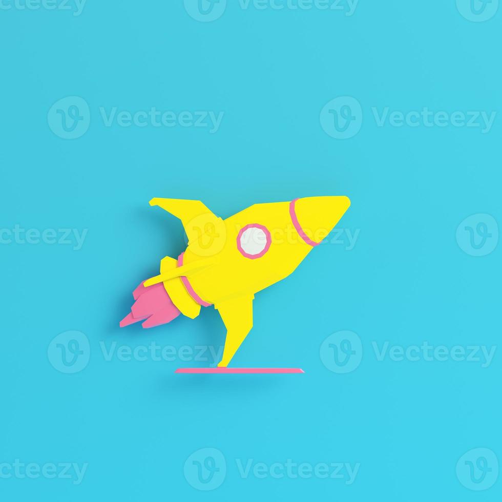 Yellow rocket with stand on bright blue background in pastel colors. Minimalism concept photo