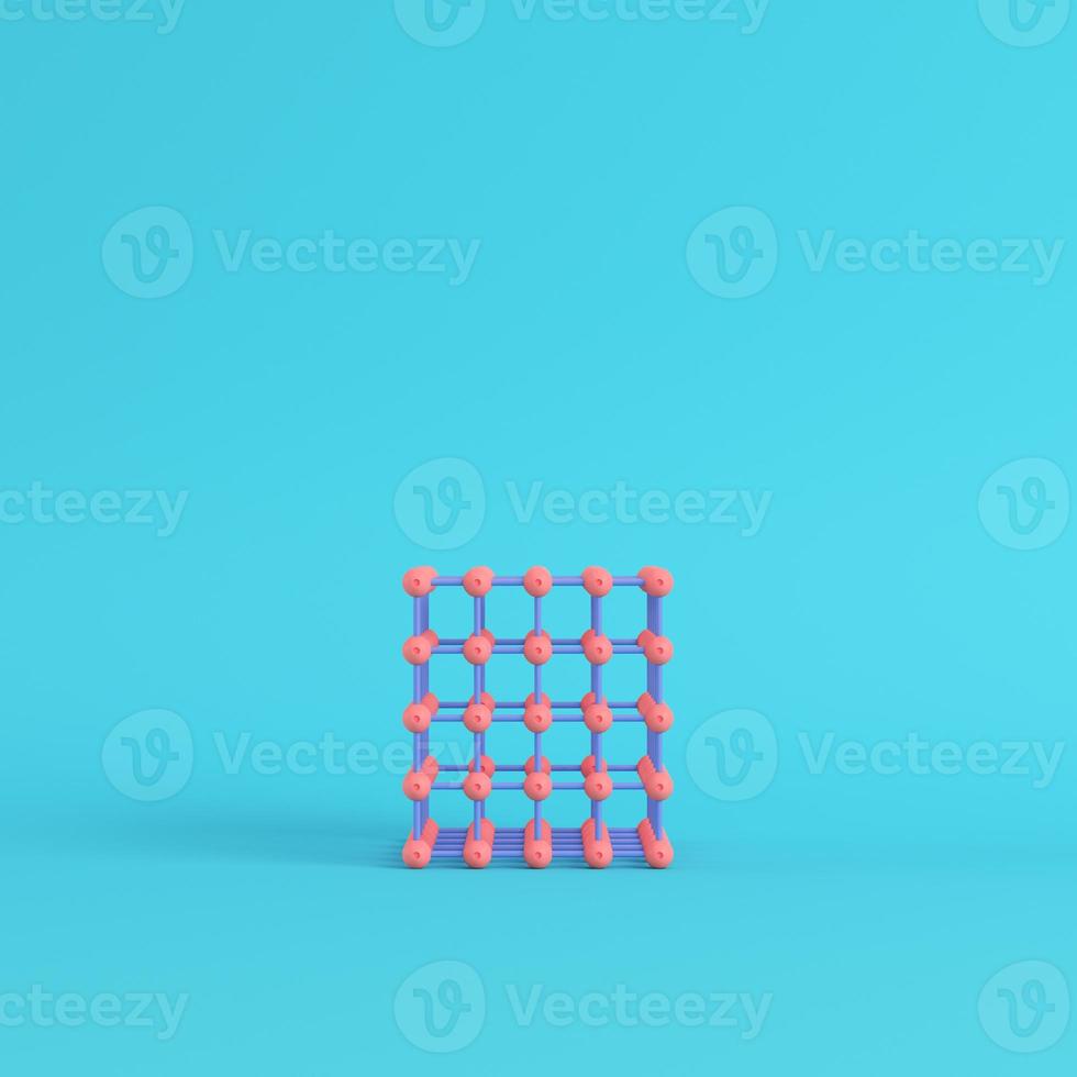 Abstract pink spheres in wire box on bright blue background in pastel colors photo