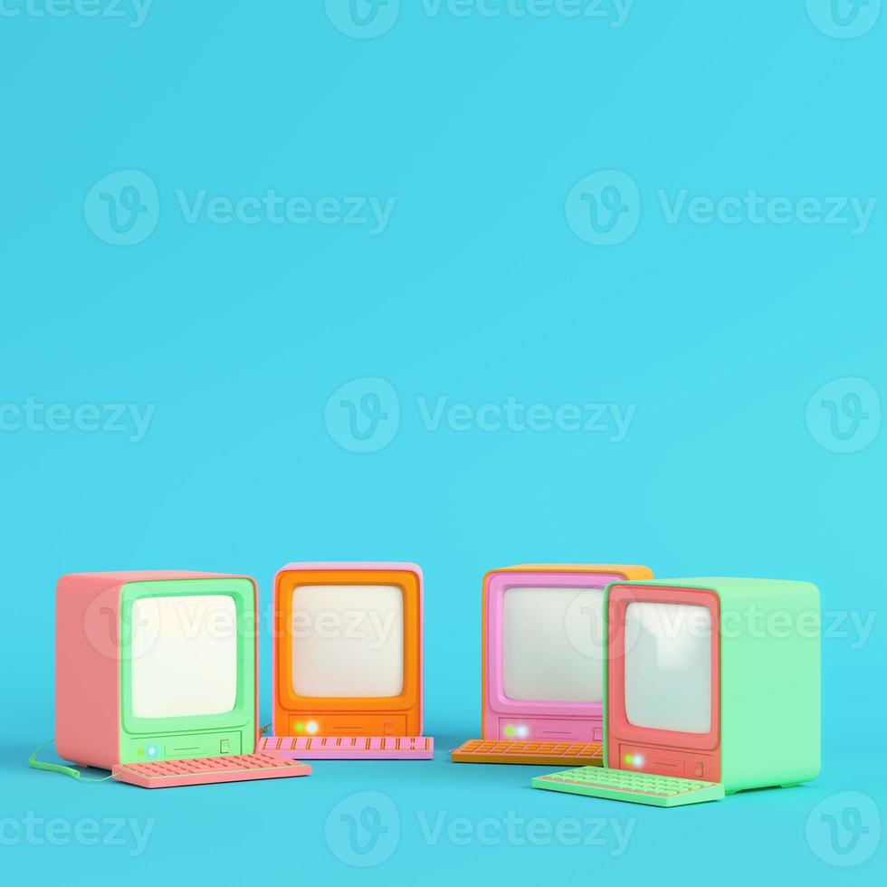 Colorful retro computers on bright blue background in pastel colors. Minimalism concept photo