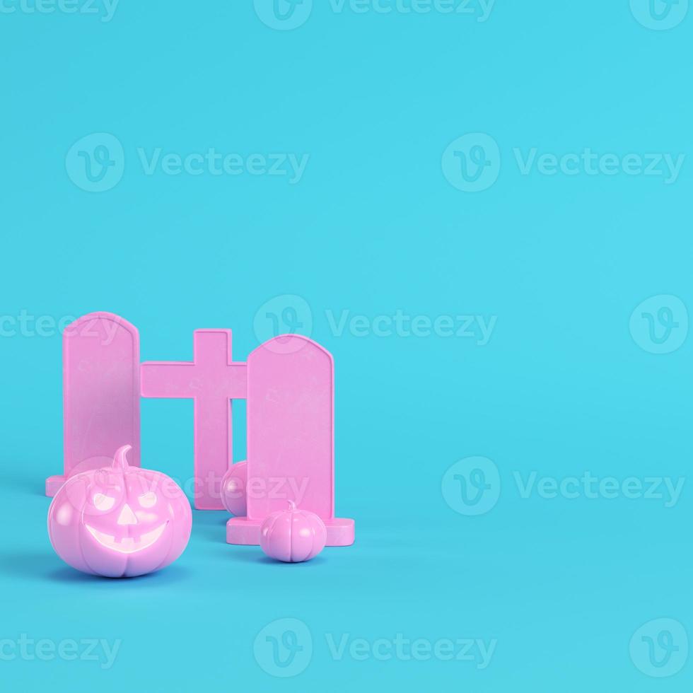 Pink halloween pumpkins with crosses and gravestones on bright blue background in pastel colors. Minimalism concept photo