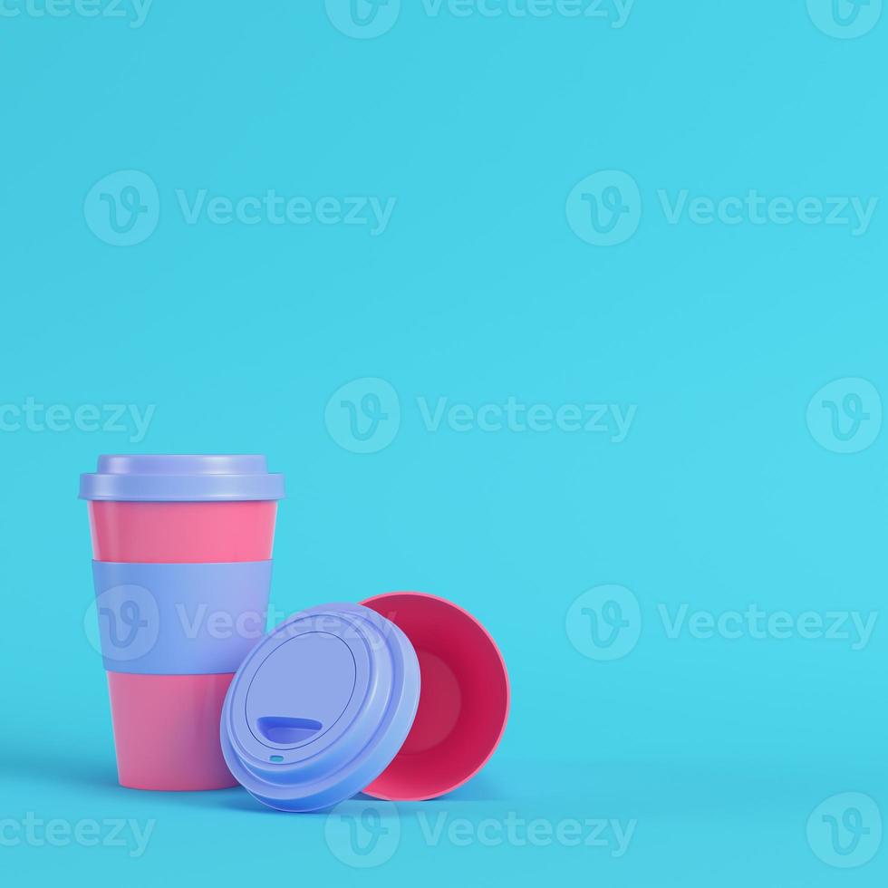 Coffee cups on bright blue background in pastel colors. Minimalism concept photo