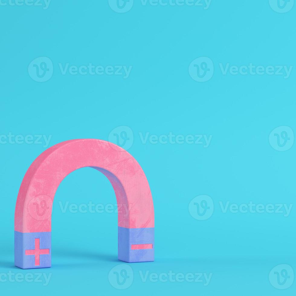 Pink magnet on bright blue background in pastel colors photo