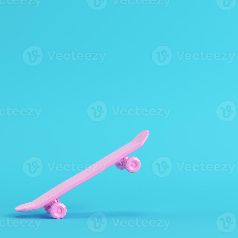 Pink low poly skateboard deck on bright blue background in pastel colors photo