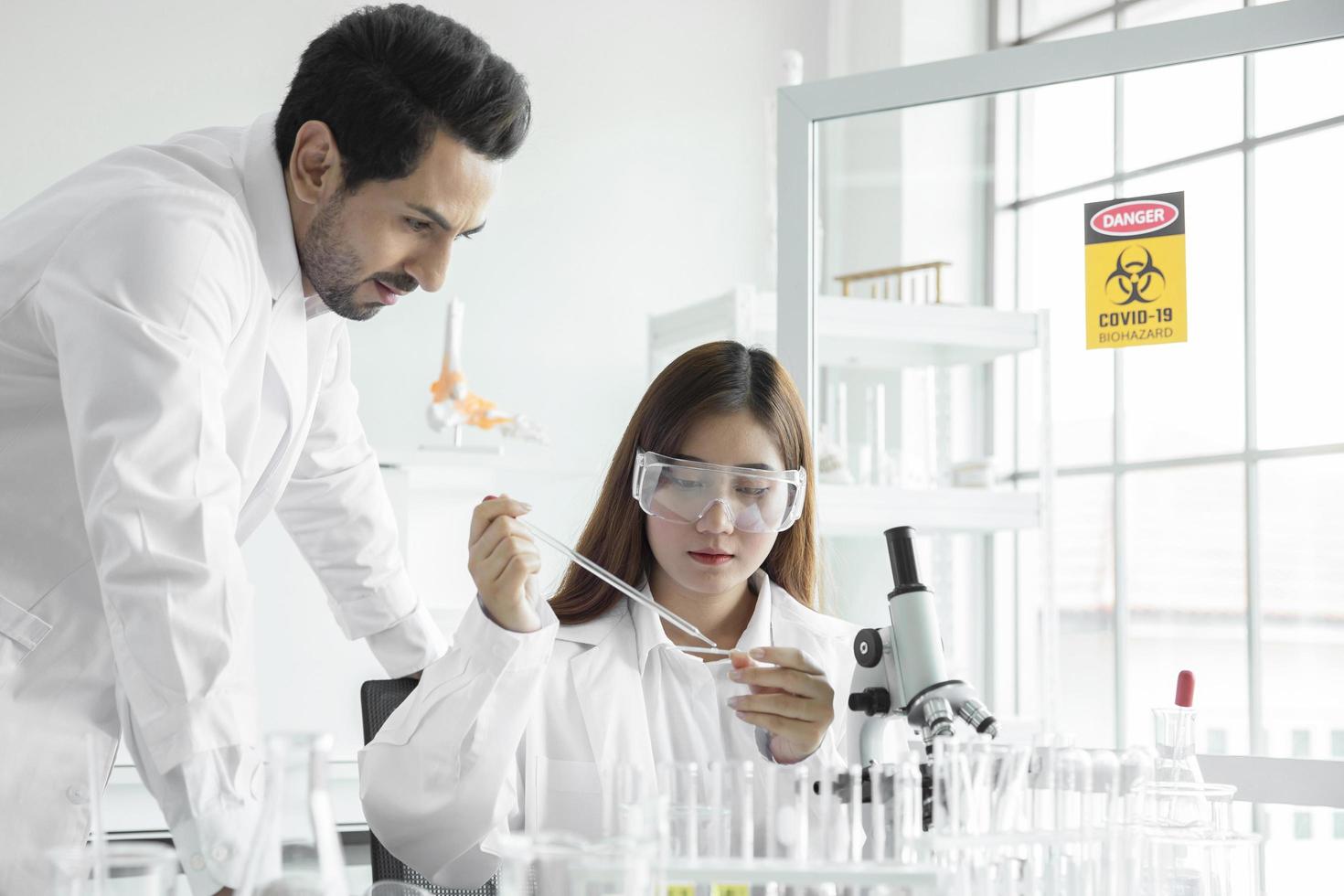 Young team scientist medical worker in lab , doing a analysis in a laboratory doing research photo