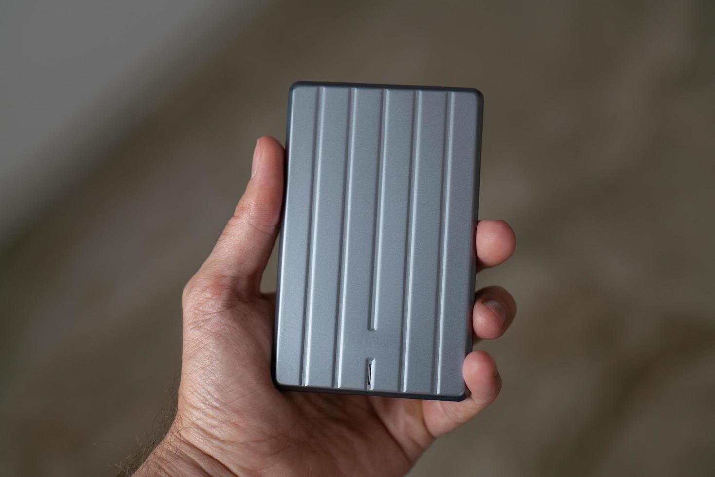 External hard drive in mans hand photo