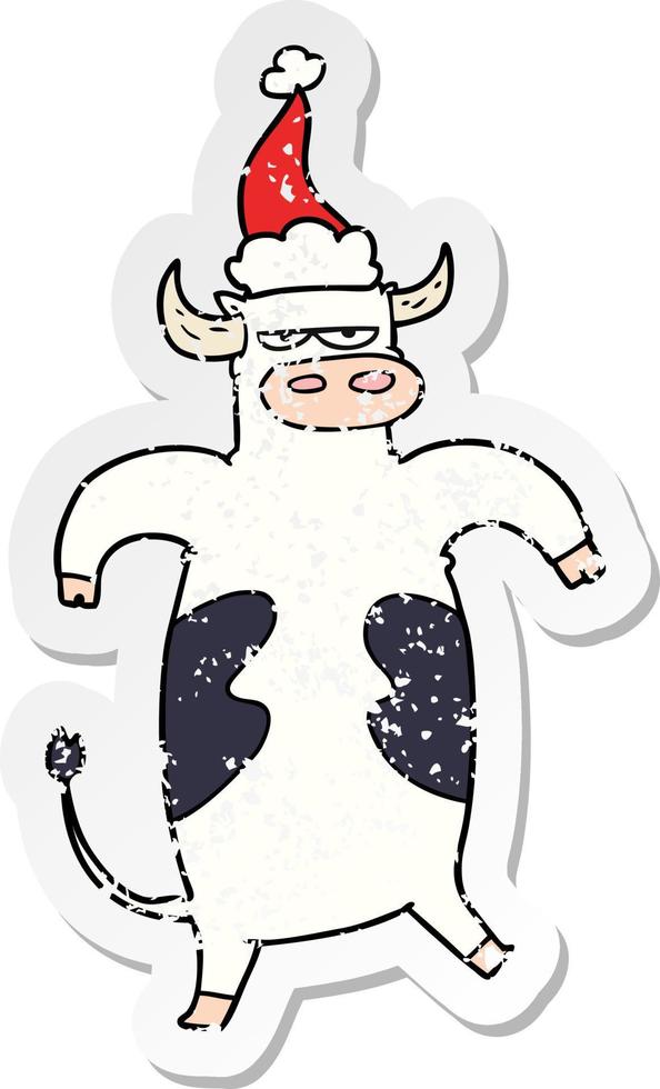 distressed sticker cartoon of a bull wearing santa hat vector