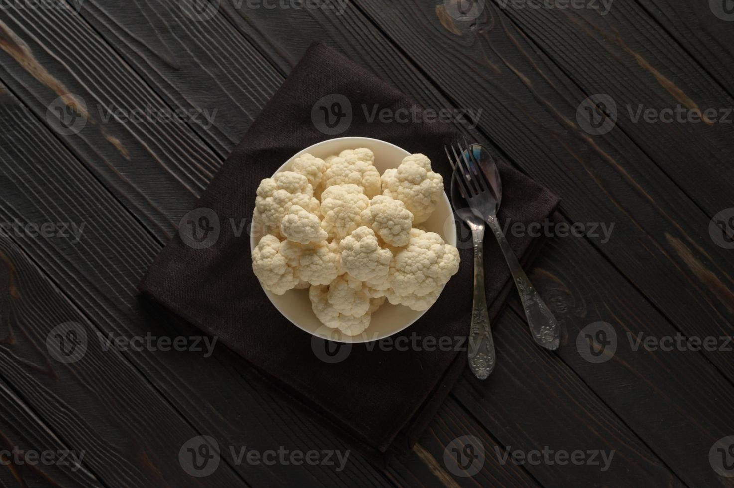 Raw, fresh organic cauliflower on a wooden background. Healthy eating, low carb diet concept photo