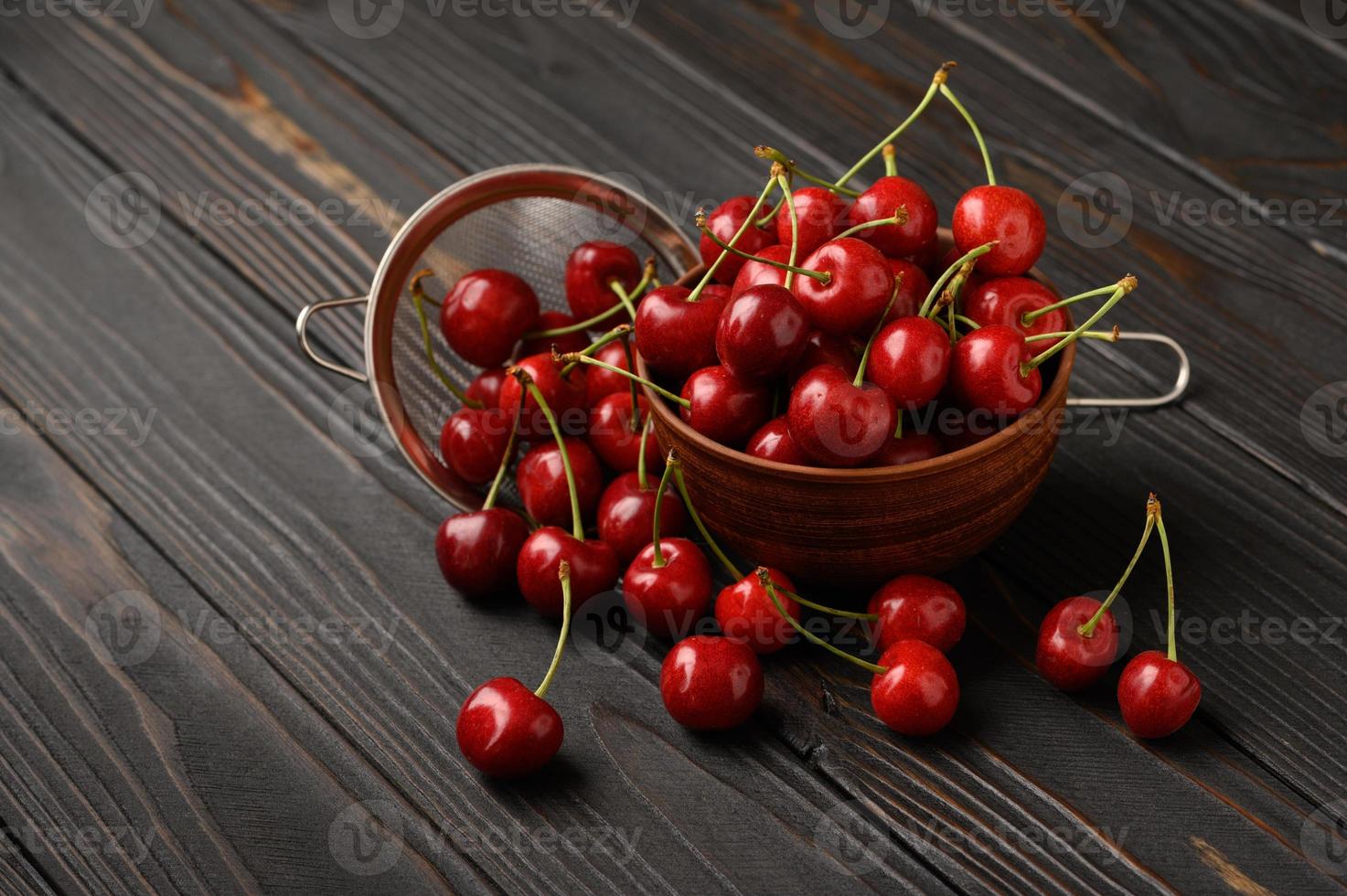 Sweet fresh cherry on a dark wooden background. photo