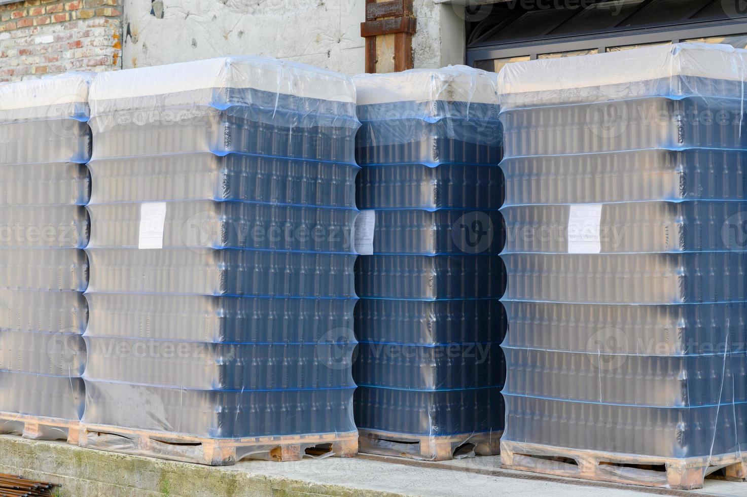 Empty beer bottles in packs stand on the territory of the brewery. photo