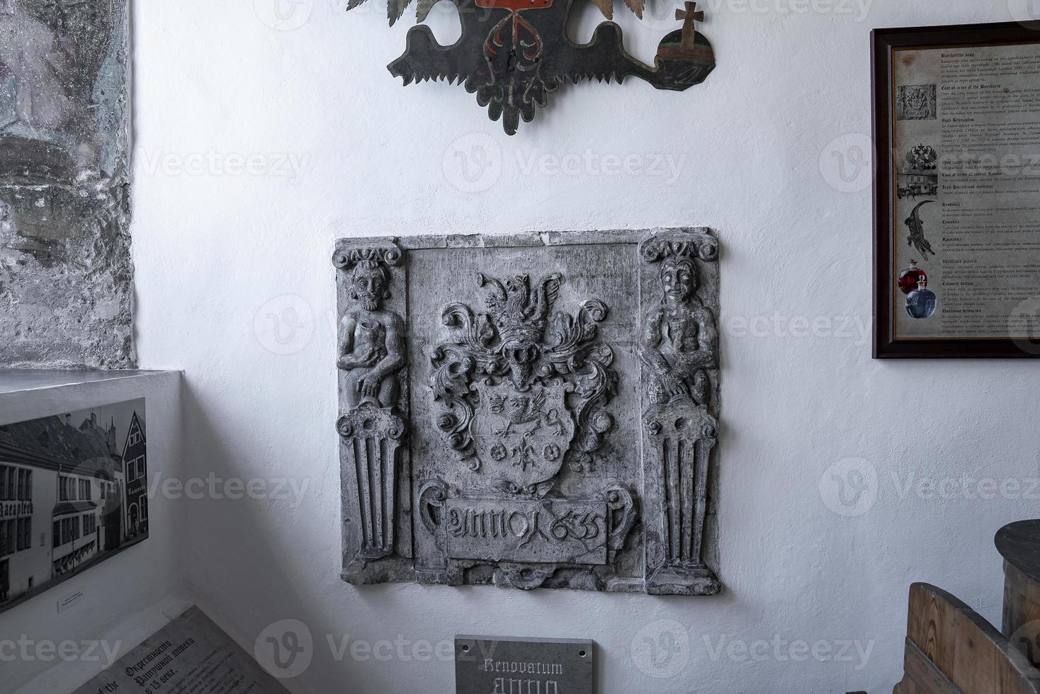 Carved structure with photographs and frames at old pharmacy museum in historic town photo