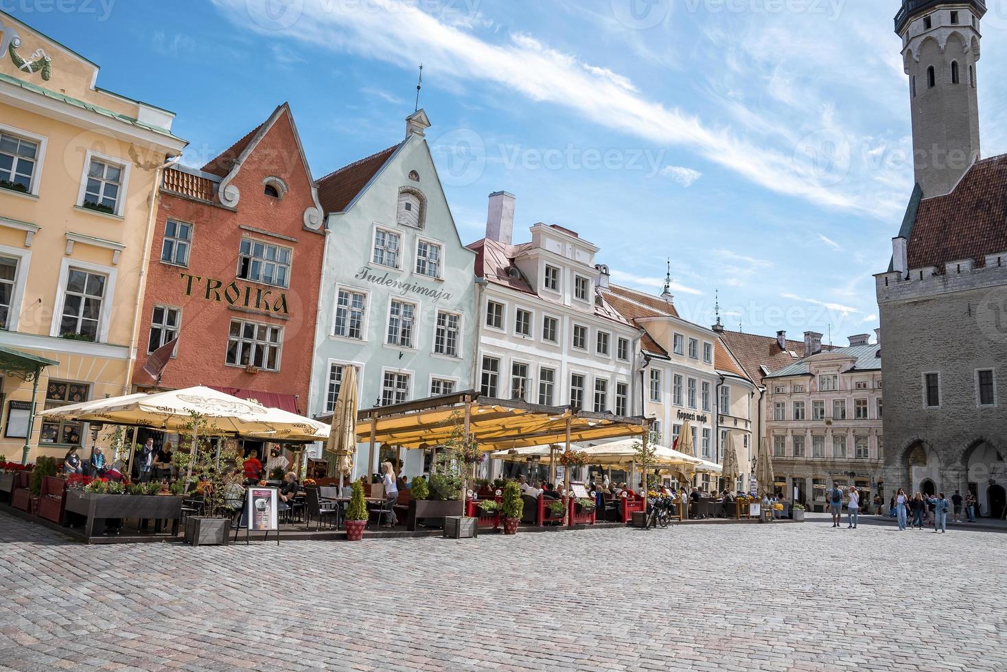 Travelers exploring market in city square at old historic town against sky photo