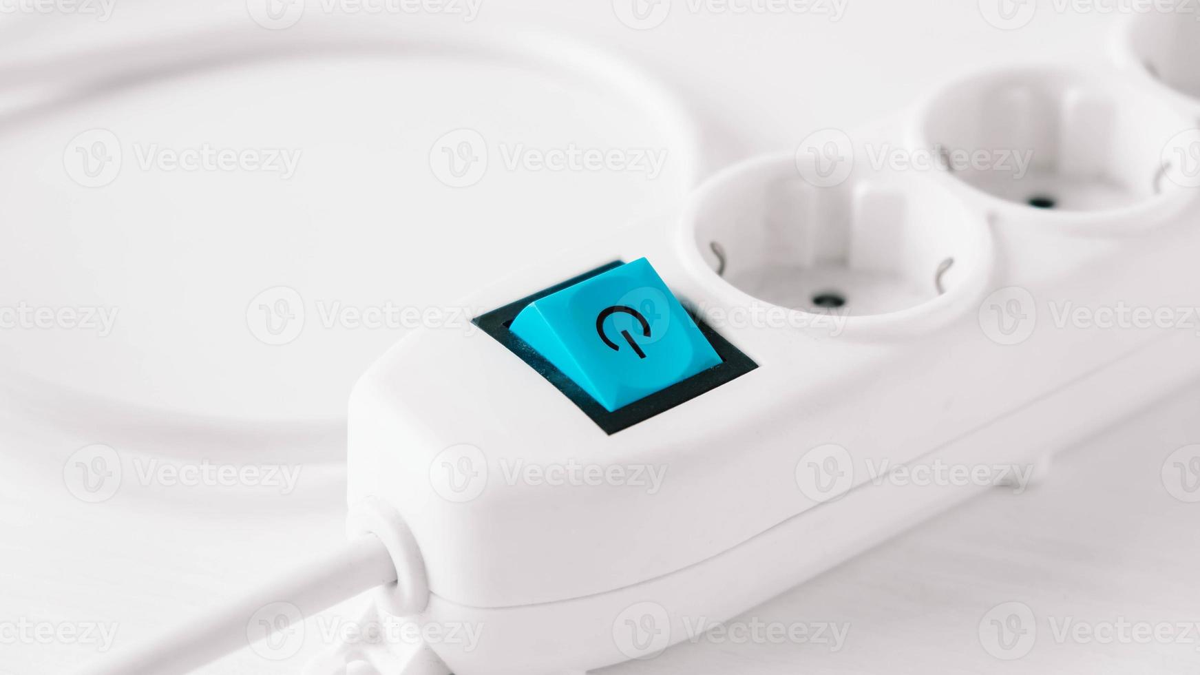 Modern white electric extension cord with a button on a white background photo