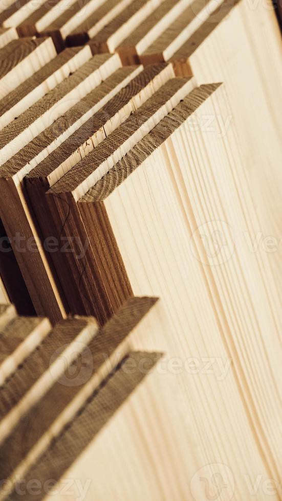 Stacked wooden carpentry boards from natural wood in a woodworking industry photo