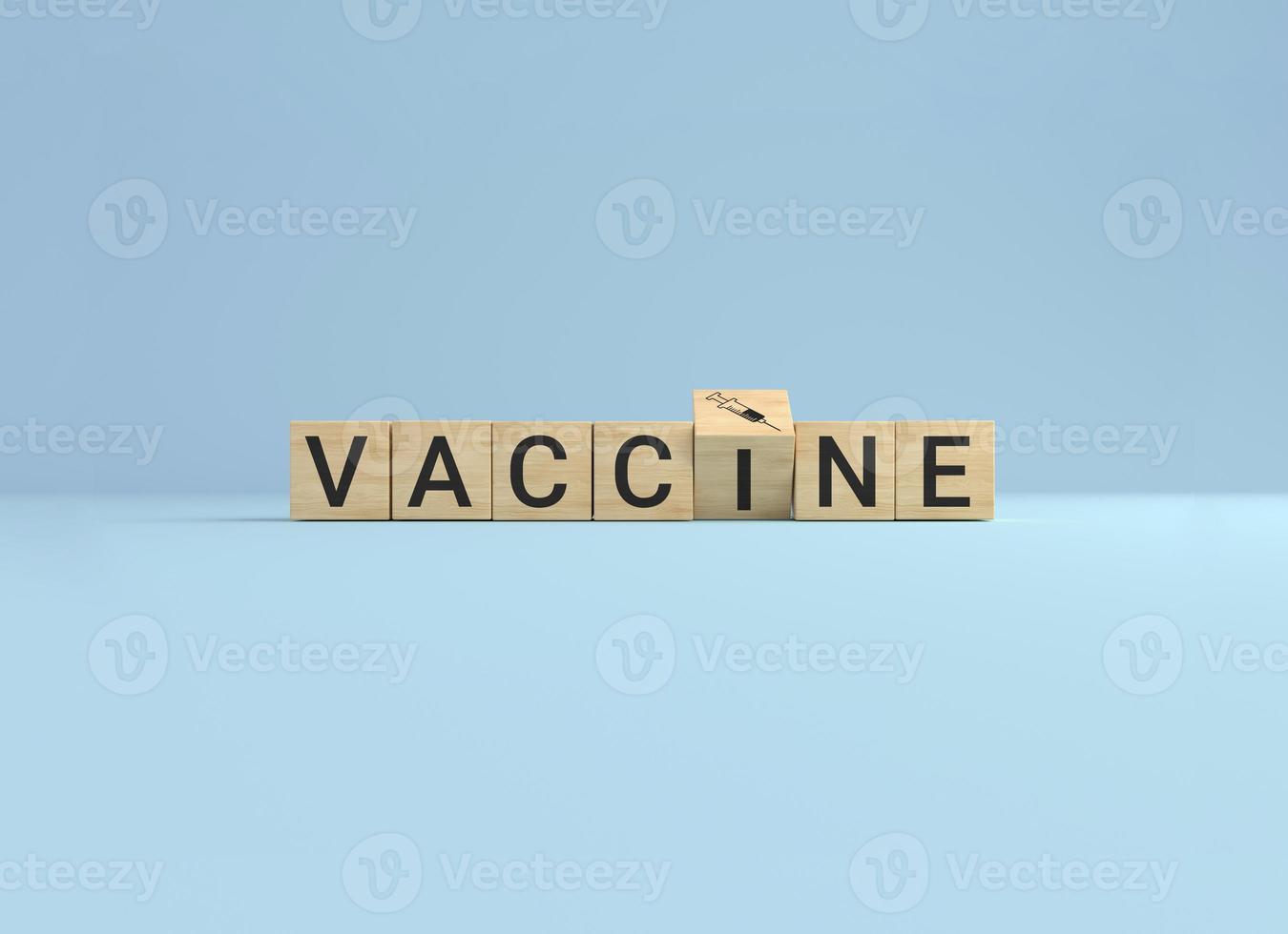 Wooden cube block flip over word vaccine to syringe icon on blue studio background. photo