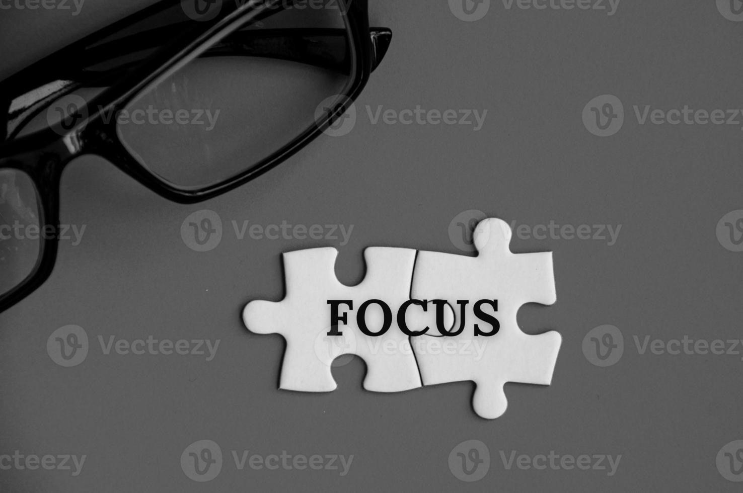 Text on missing jigsaw puzzle - Focus. With grey background. photo