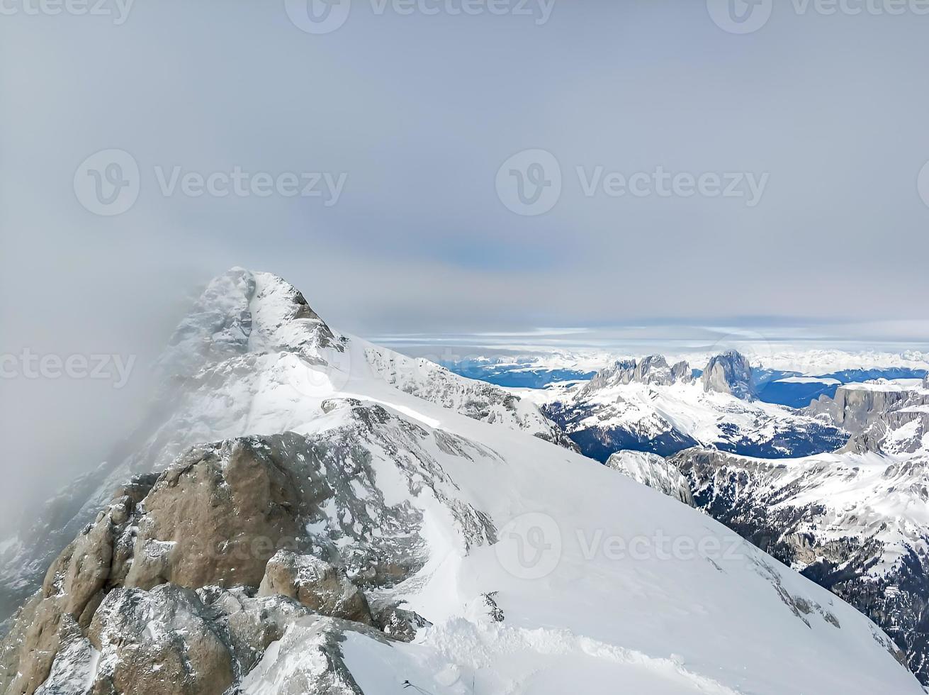 Beautiful snowy mountain tops in the clouds. photo