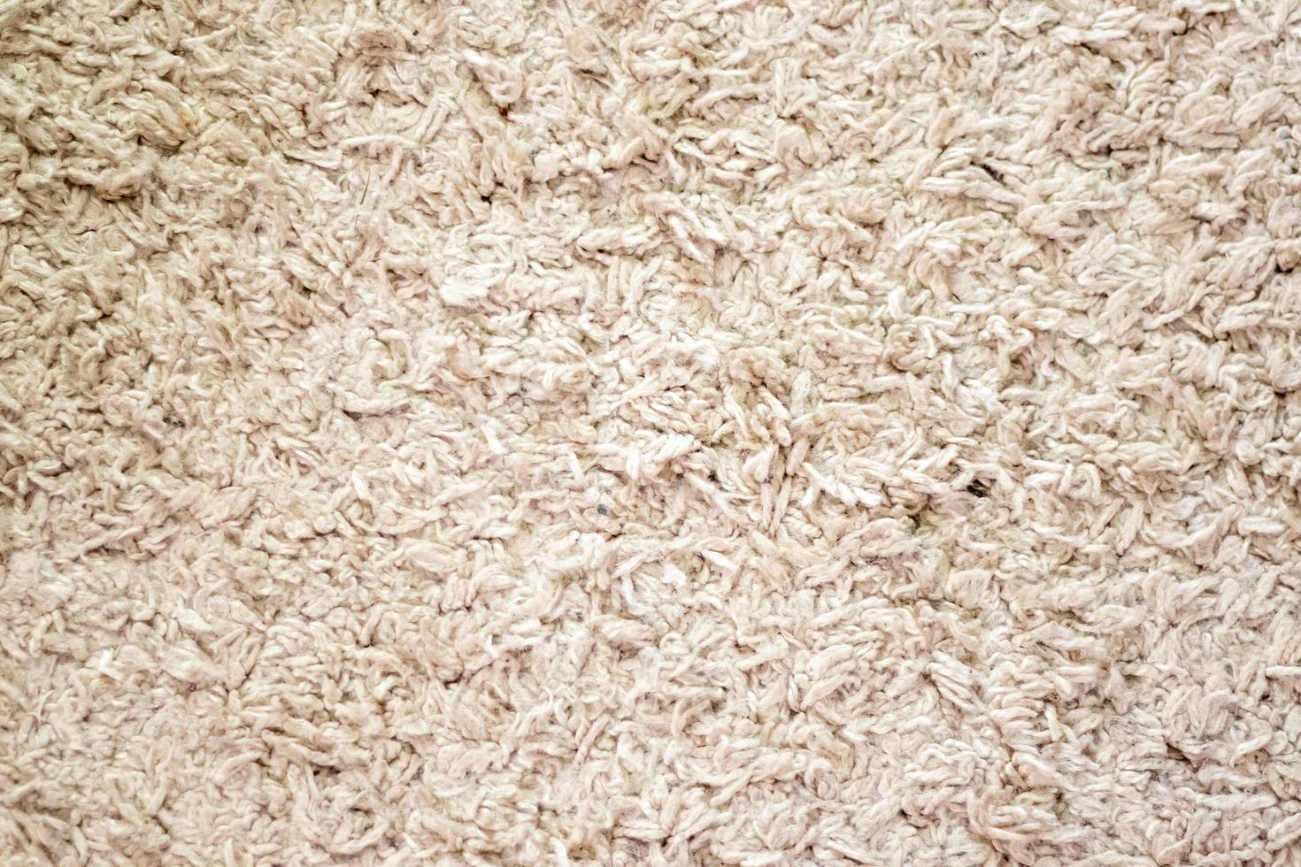 Beige background texture of towel or home carpet. Top view, flat lay. Textile texture of carpet. White or cream pile carpet. Stylish carpet on the floor in the room. Interior Design. photo