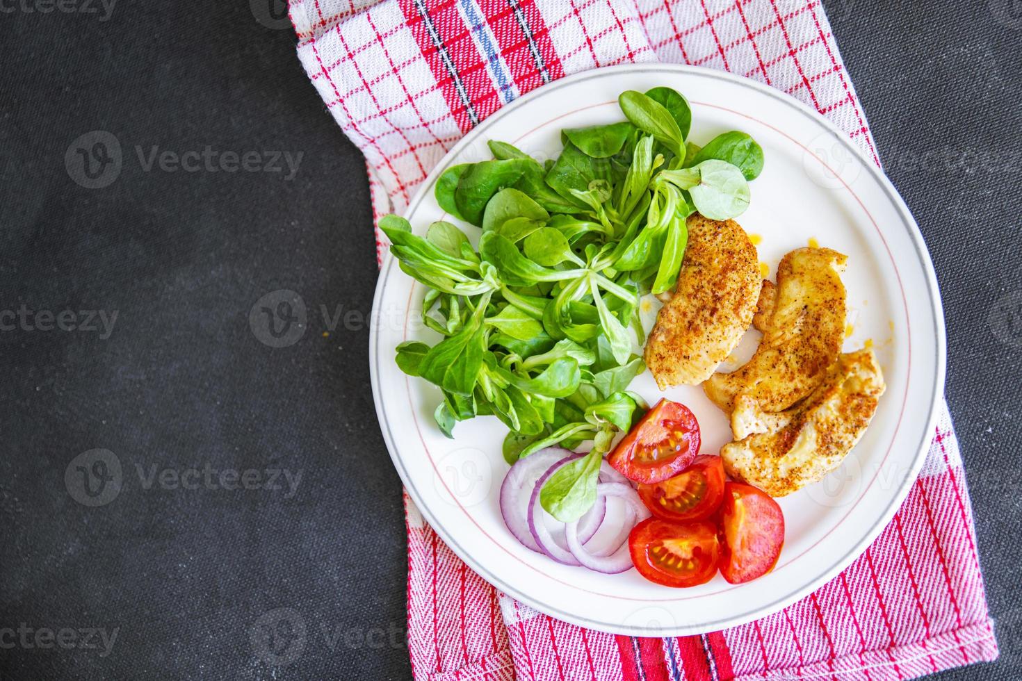 salad vegetables, fried chicken, green lettuce leaves cuisine fresh healthy meal food snack diet on the table copy space food background rustic top view keto or paleo diet photo