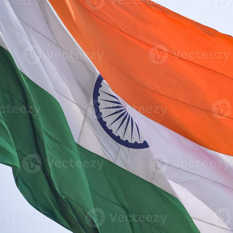 India flag flying high at Connaught Place with pride in blue sky, India flag fluttering, Indian Flag on Independence Day and Republic Day of India, tilt up shot, waving Indian flag, Flying India flags photo