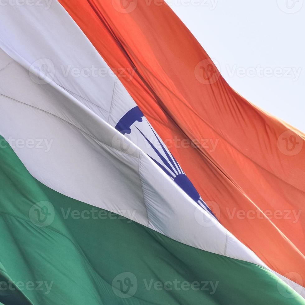 India flag flying high at Connaught Place with pride in blue sky, India flag fluttering, Indian Flag on Independence Day and Republic Day of India, tilt up shot, waving Indian flag, Flying India flags photo