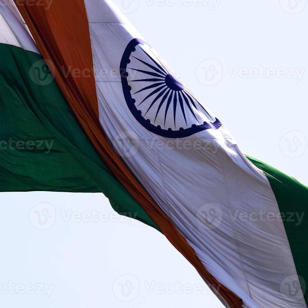 India flag flying high at Connaught Place with pride in blue sky, India flag fluttering, Indian Flag on Independence Day and Republic Day of India, tilt up shot, waving Indian flag, Flying India flags photo