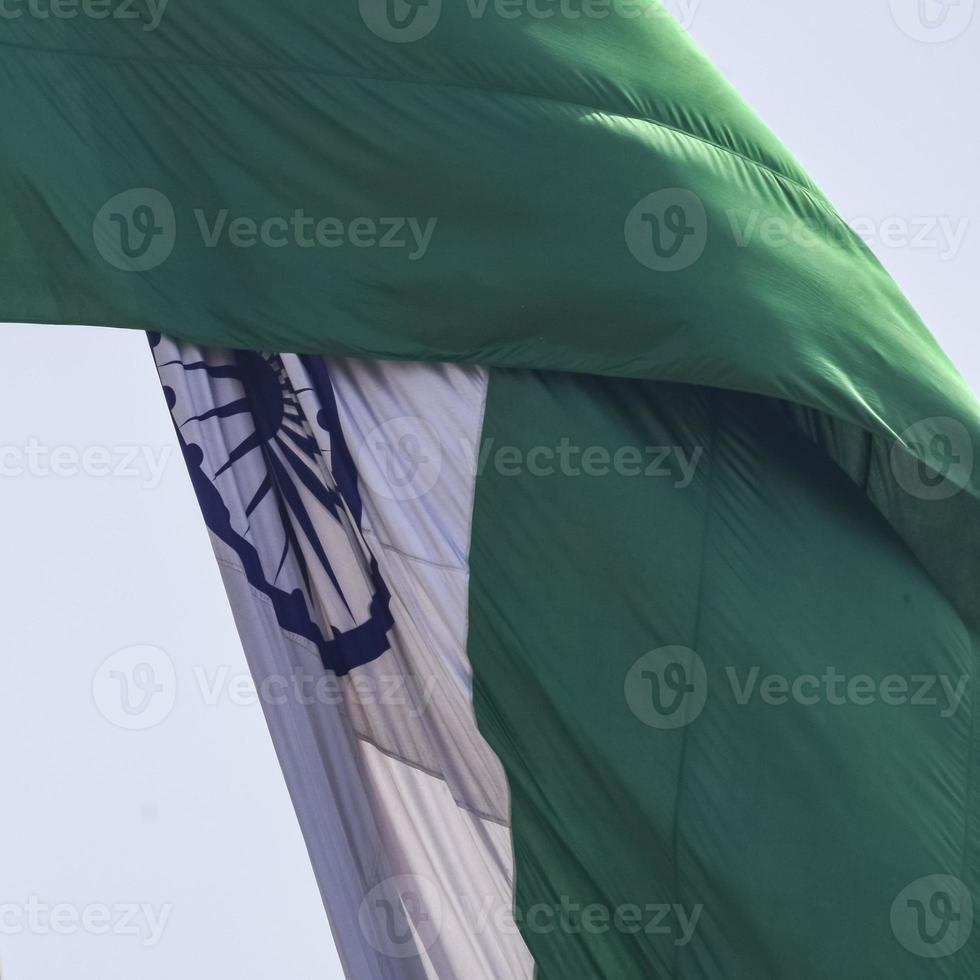 India flag flying high at Connaught Place with pride in blue sky, India flag fluttering, Indian Flag on Independence Day and Republic Day of India, tilt up shot, waving Indian flag, Flying India flags photo