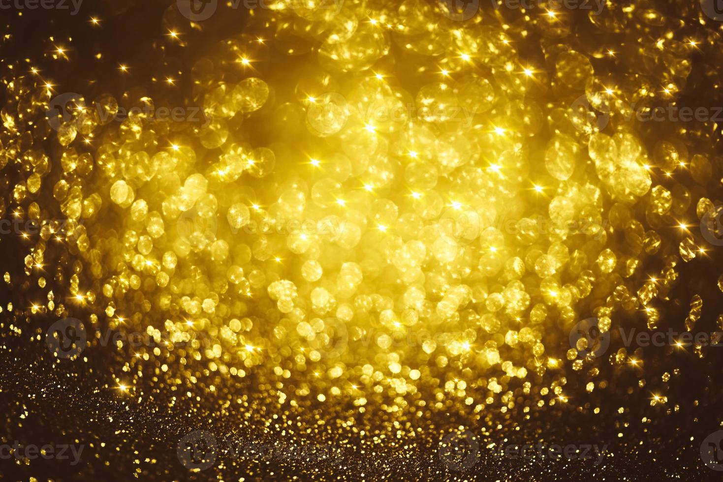 Golden glitter bokeh lighting texture Blurred abstract background for birthday, anniversary, wedding, new year eve or Christmas photo