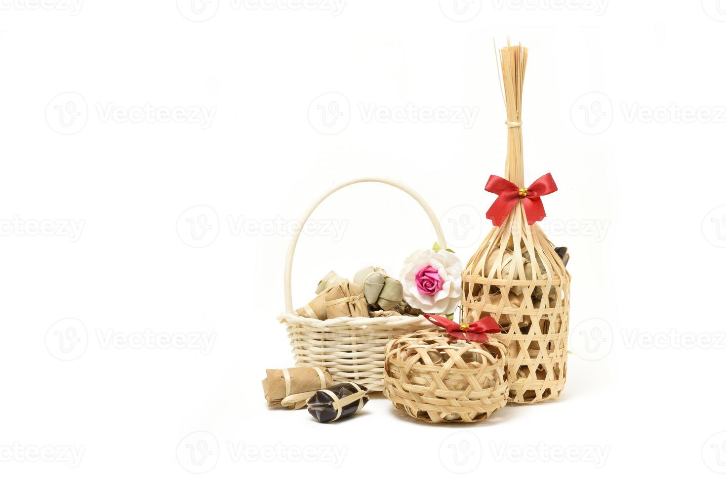 Thai traditional dessert in wicker bamboo basket On white background photo