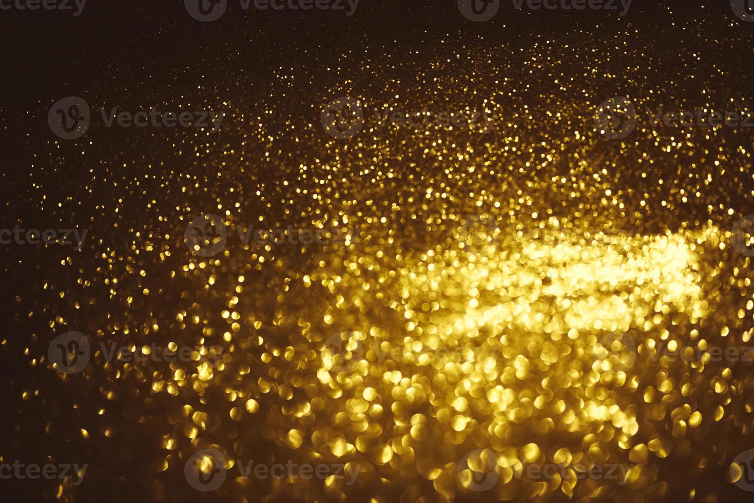 Golden glitter bokeh lighting texture Blurred abstract background for birthday, anniversary, wedding, new year eve or Christmas photo